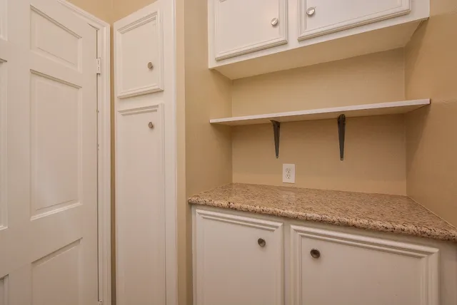 a room with cabinets and wooden floor