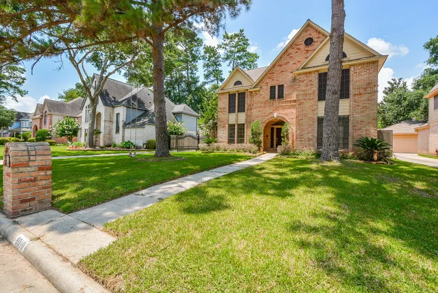 a front view of house with yard and green space