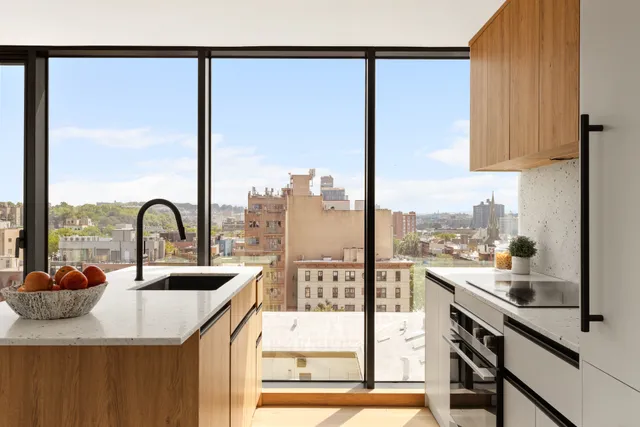a view of a kitchen with a sink and cabinets
