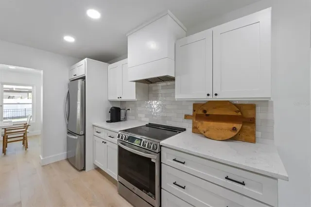 a kitchen with granite countertop a stove and a refrigerator