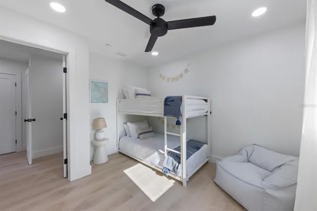 a living room with furniture and a ceiling fan