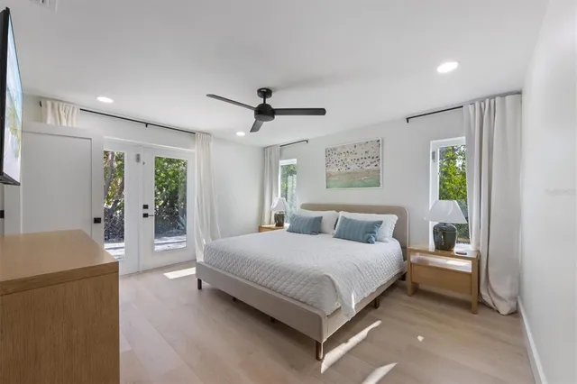 a bedroom with a large bed and a chandelier