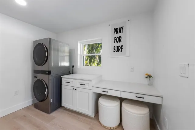 a utility room with sink dryer and washer
