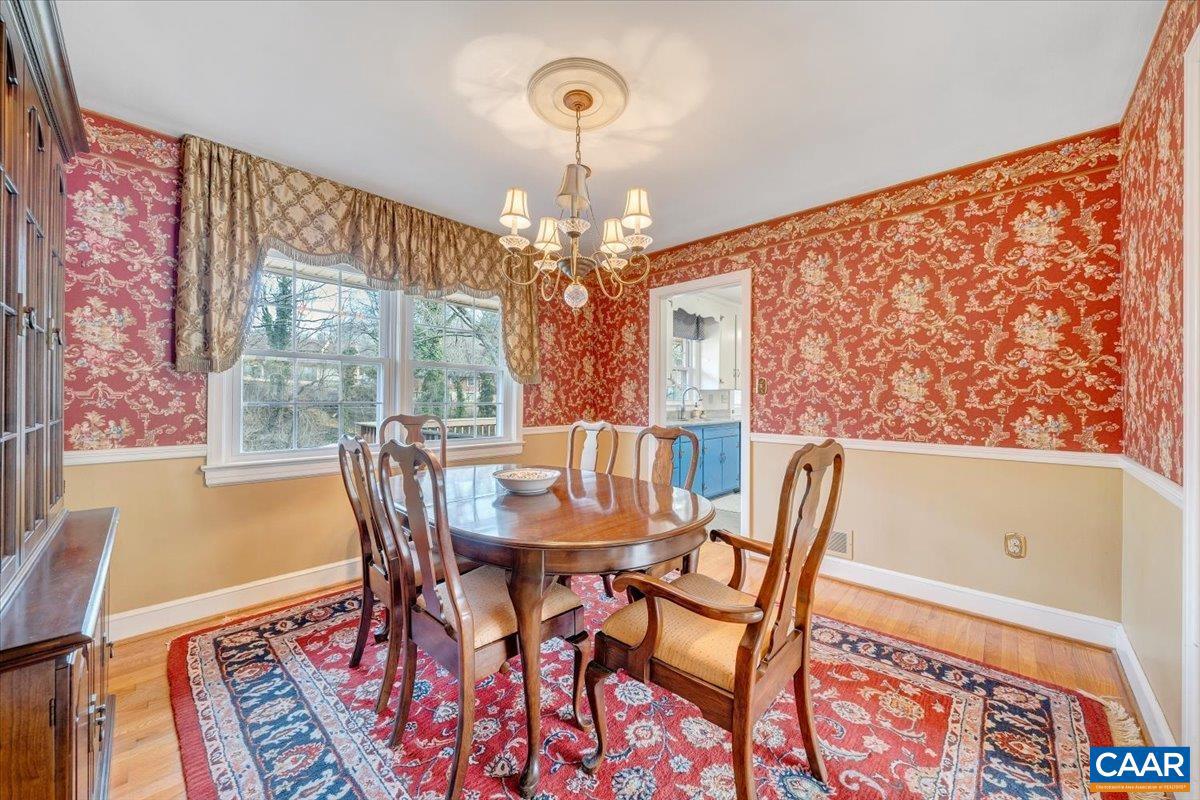 3558 Hartland Road Southwest Roanoke, VA 24015 - Photo 14 of 73 a view of a dining room with furniture wooden floor and chandelier