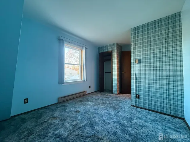 a view of a livingroom with a ceiling fan and window