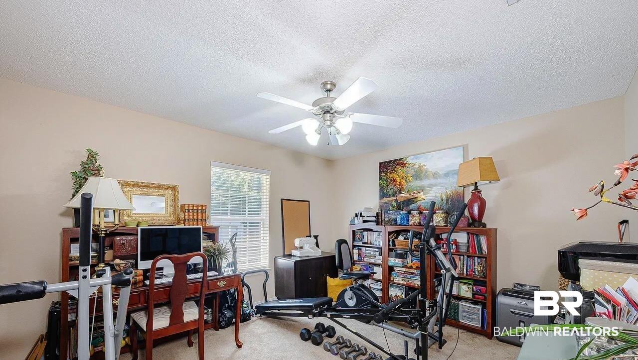 12230 Bromley Road Stapleton, AL 36578 - Photo 26 of 34 Workout area featuring light carpet, a textured ceiling, and ceiling fan