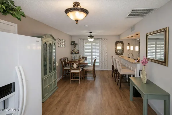 a view of a dining room with furniture and wooden floor