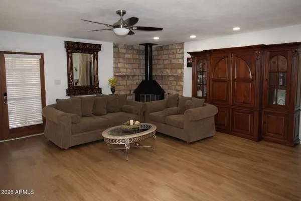 a living room with furniture a ceiling fan and a rug