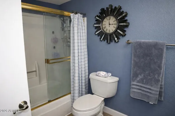 a bathroom with a toilet sink and shower