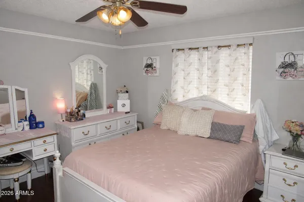 a bedroom with a bed and a chandelier