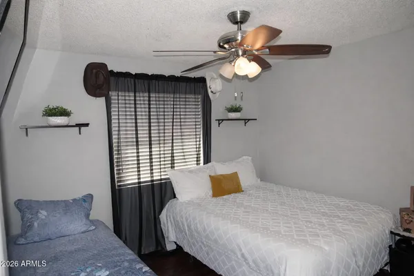 a bedroom with a bed and a chandelier