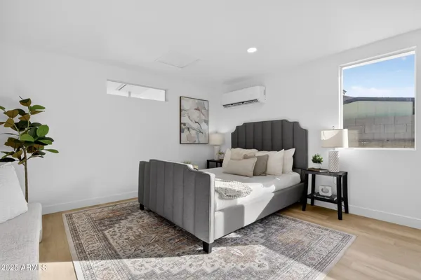 a living room with a couch and a potted plant