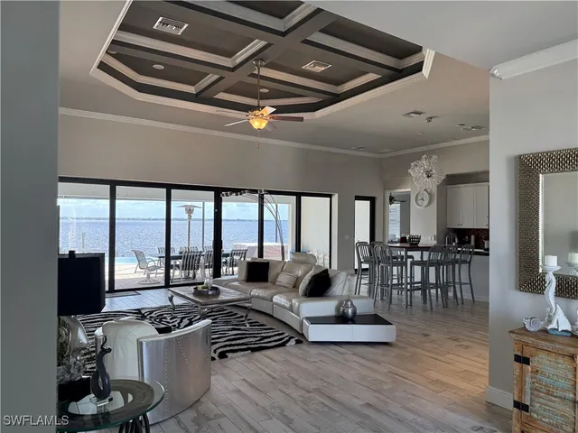 a very nice looking living room with a large window a couch and a table