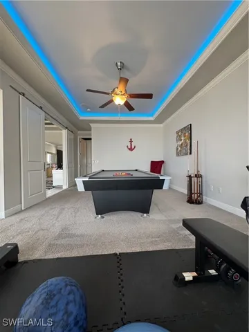 a living room with furniture and a pool table