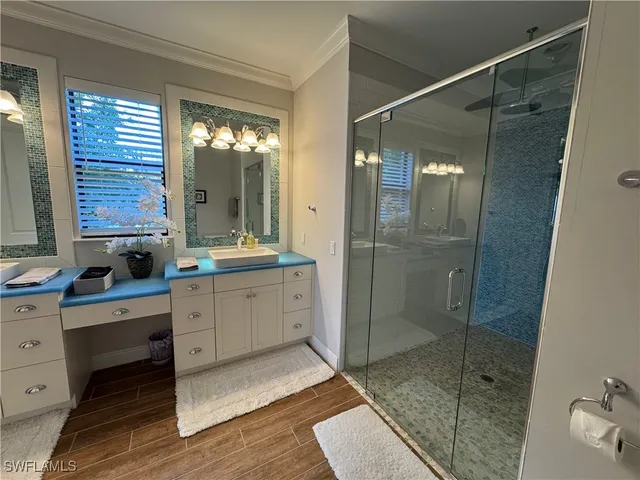 a bathroom with a shower sink and mirror