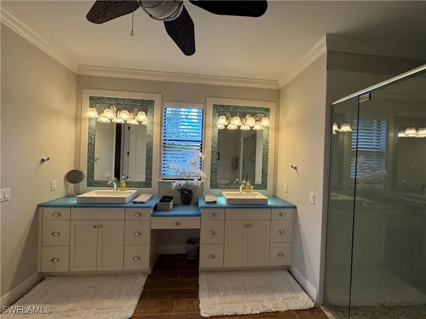 a bathroom with a double vanity sink a mirror and a shower