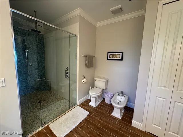 a bathroom with a granite countertop shower and a toilet