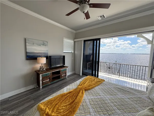 a living room with a bed furniture and a large window
