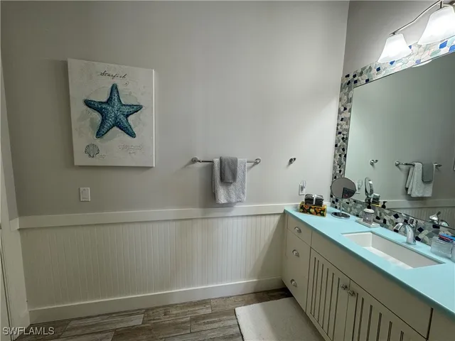 a bathroom with a sink a mirror and vanity