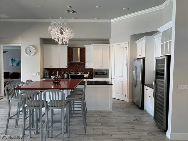 a view of a dining room with furniture and chandelier