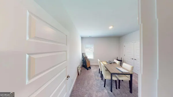 a view of a hallway with seating space