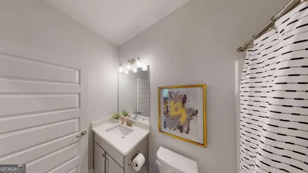 a bathroom with a sink mirror and vanity