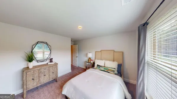 a bedroom with a bed window and a dresser