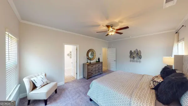 a bedroom with a bed and a couch