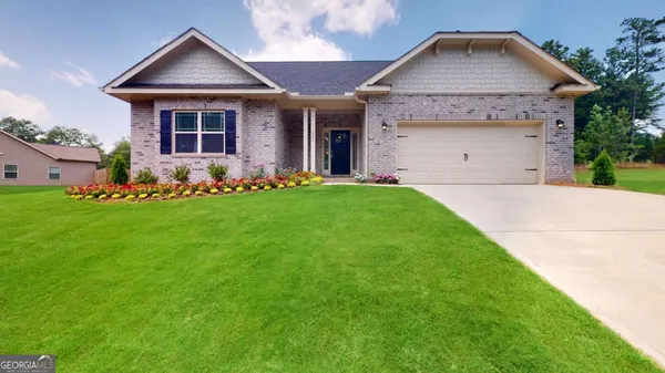 a front view of a house with a yard