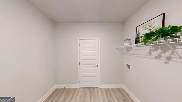 a view of a room with wooden floor