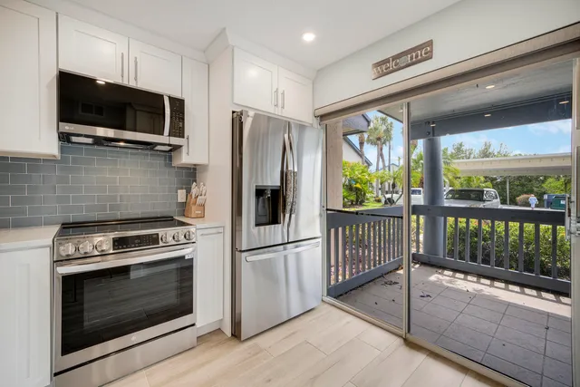 a dining room with furniture and a floor to ceiling window