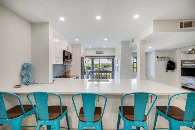 a living room with furniture a ceiling fan and a rug