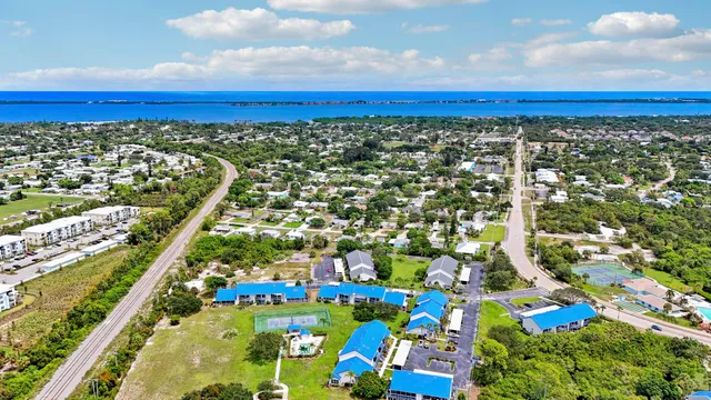 a view of a lake with couches chairs and city view