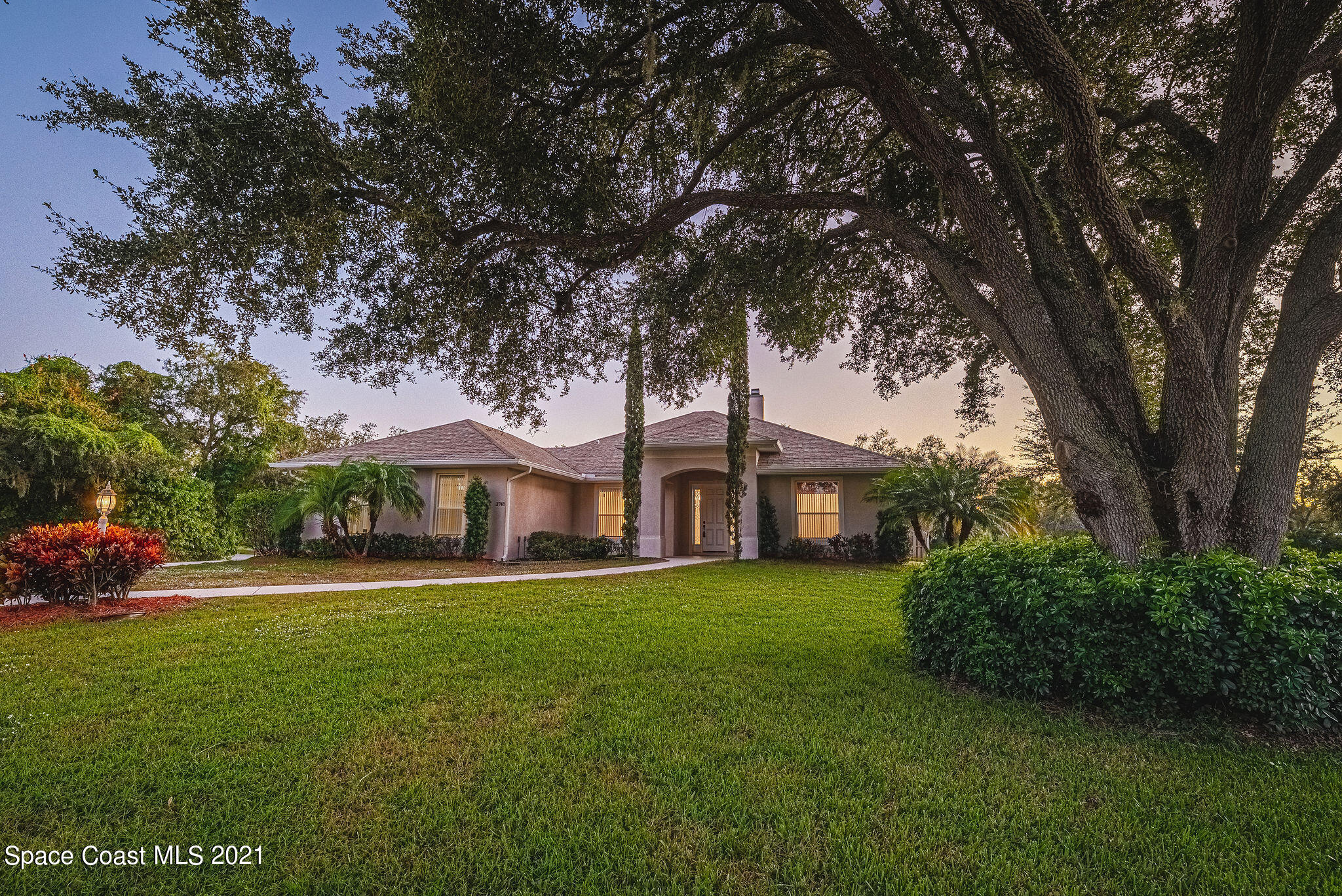 3748 Turtle Mound Road Melbourne, FL 32934 - Photo 1 of 68 a front view of a house with a garden