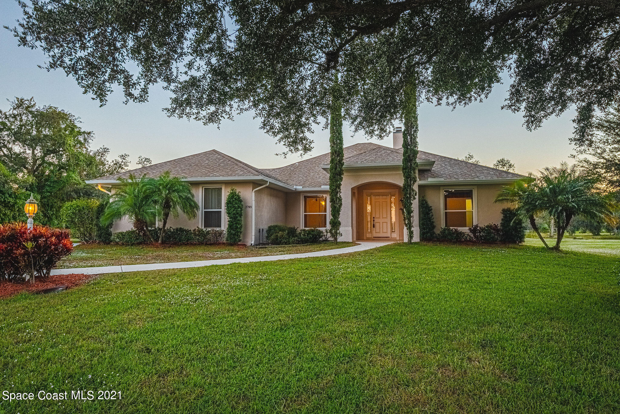 3748 Turtle Mound Road Melbourne, FL 32934 - Photo 2 of 68 a front view of a house with a garden