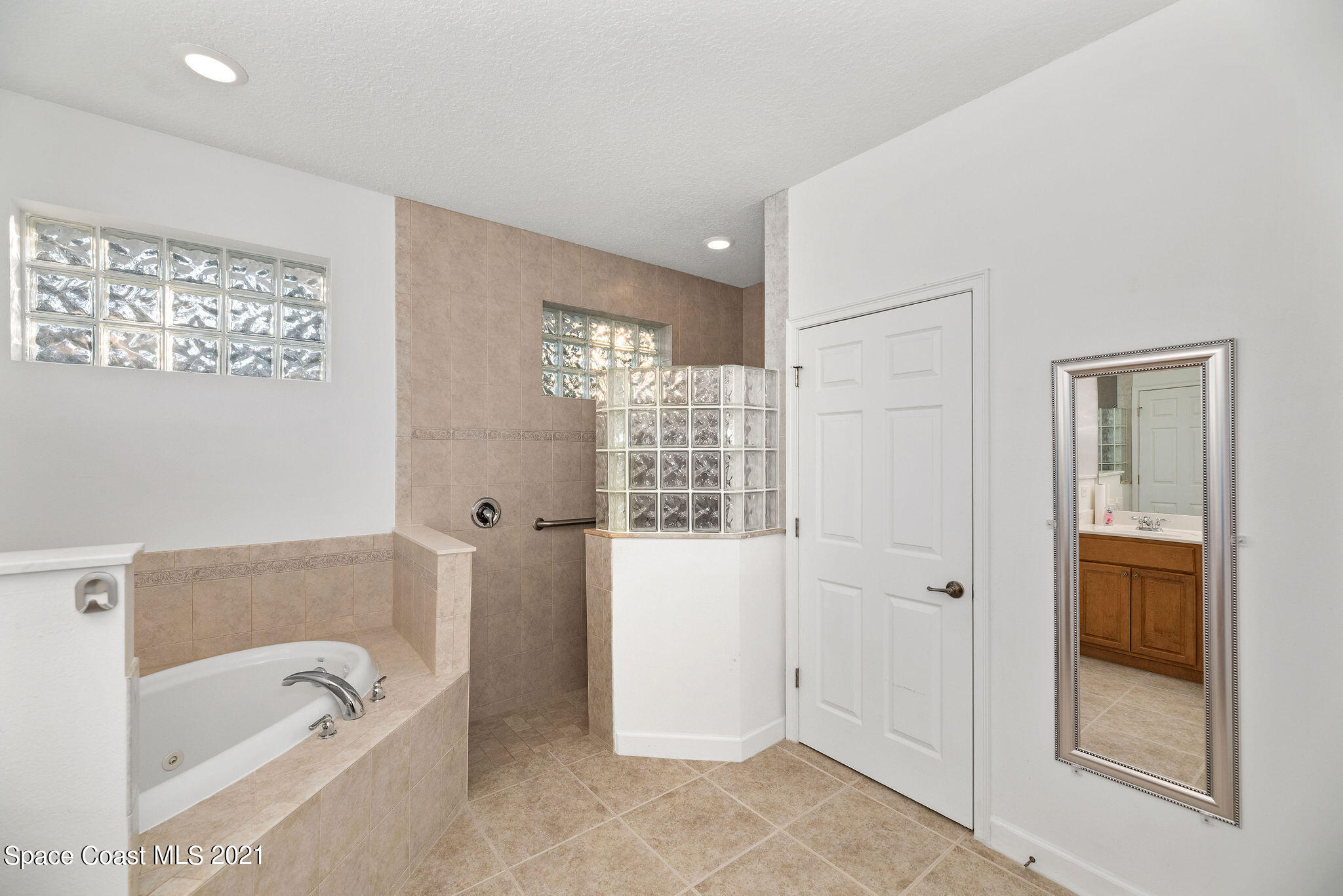 3748 Turtle Mound Road Melbourne, FL 32934 - Photo 27 of 68 a bathroom with a tub shower and sink