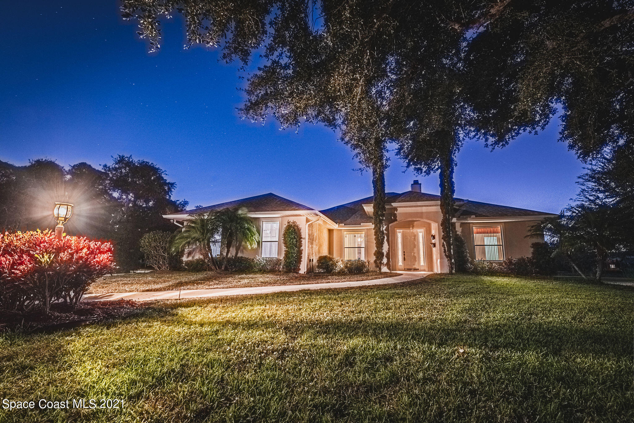 3748 Turtle Mound Road Melbourne, FL 32934 - Photo 47 of 68 a front view of a house with a yard yard and outdoor seating