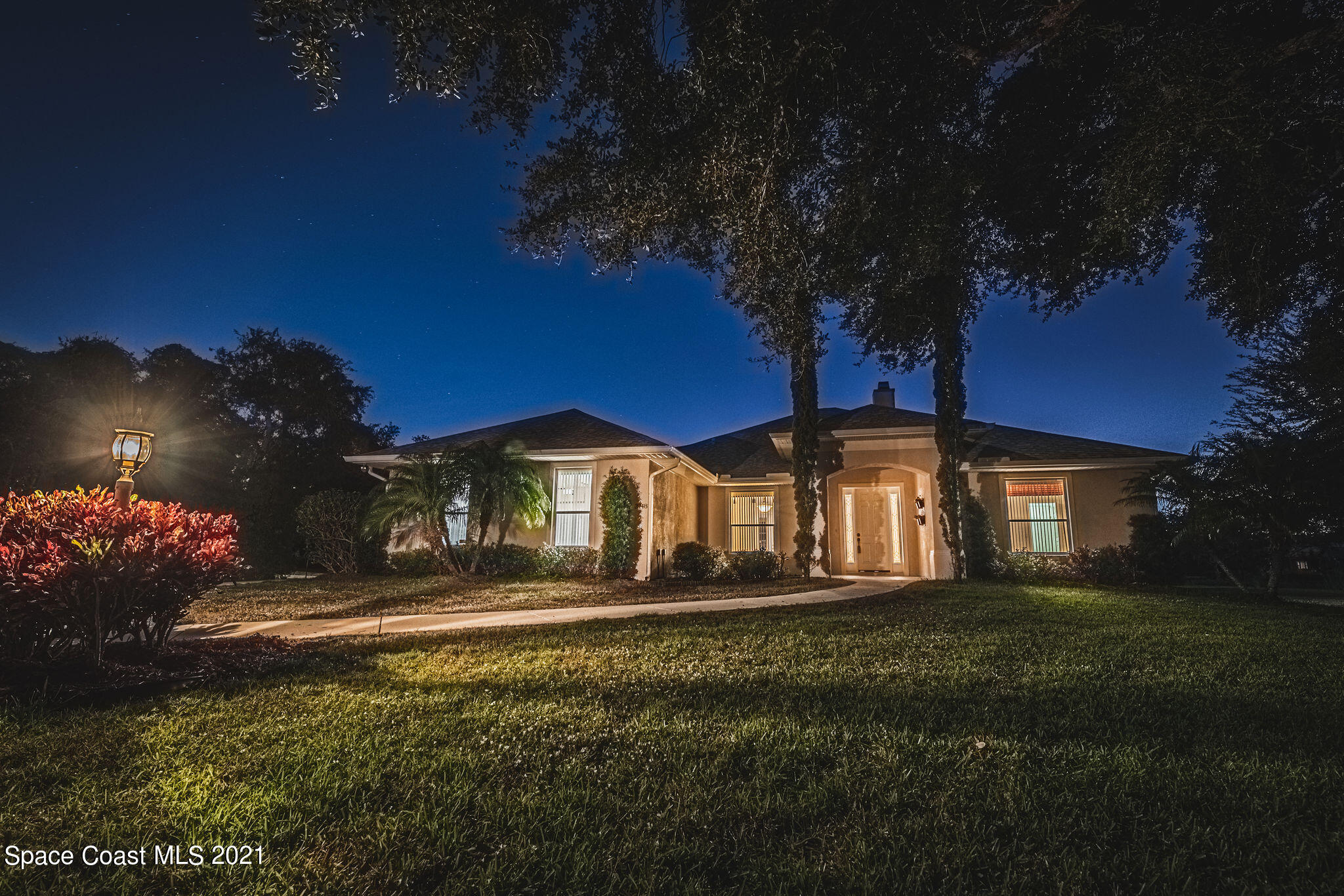 3748 Turtle Mound Road Melbourne, FL 32934 - Photo 48 of 68 a front view of a house with a yard
