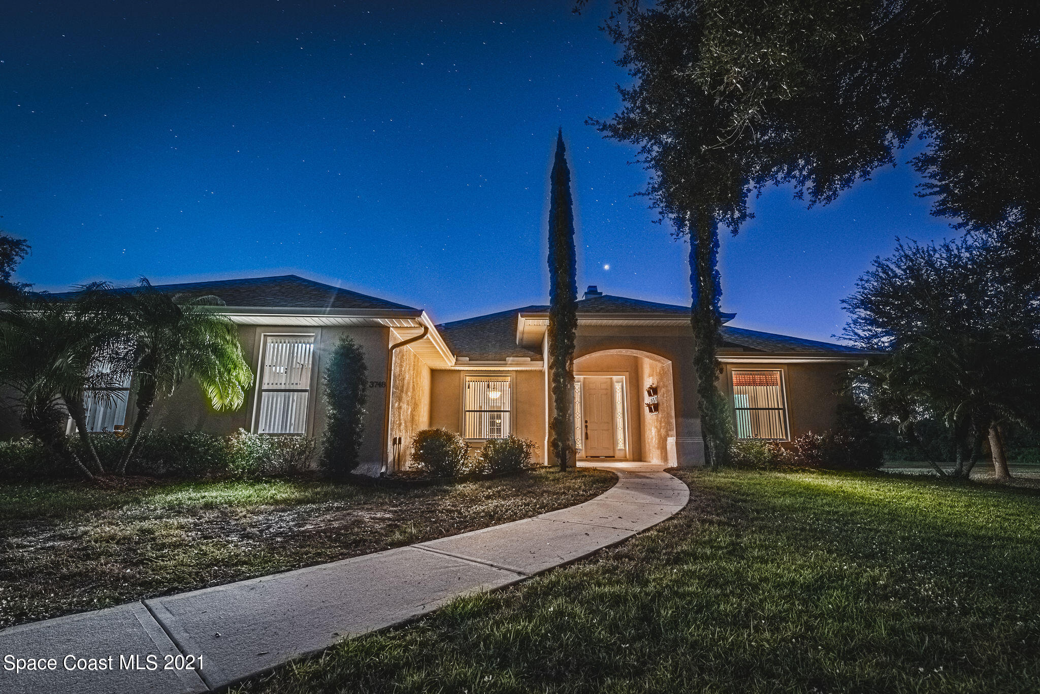3748 Turtle Mound Road Melbourne, FL 32934 - Photo 50 of 68 a front view of a house with garden