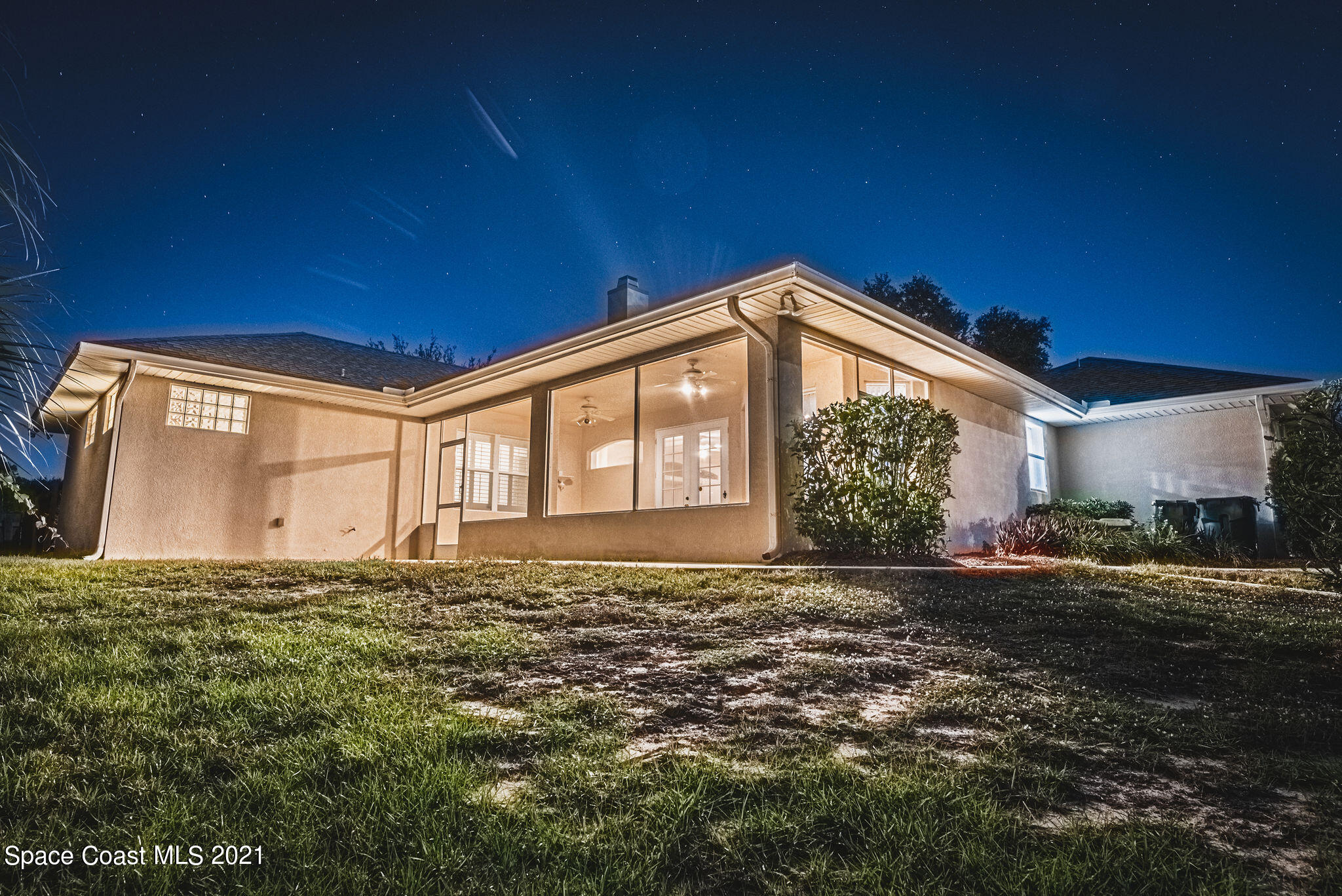 3748 Turtle Mound Road Melbourne, FL 32934 - Photo 52 of 68 a big house with a big yard and large trees