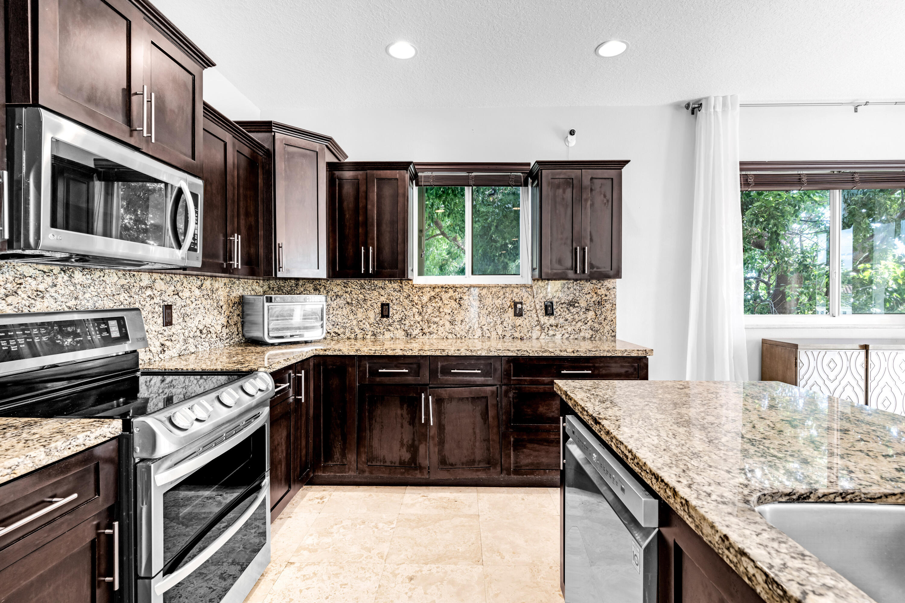 427 4th Road Key Largo, FL 33037 - Photo 8 of 51 a kitchen with stainless steel appliances granite countertop a stove top oven a sink and dishwasher