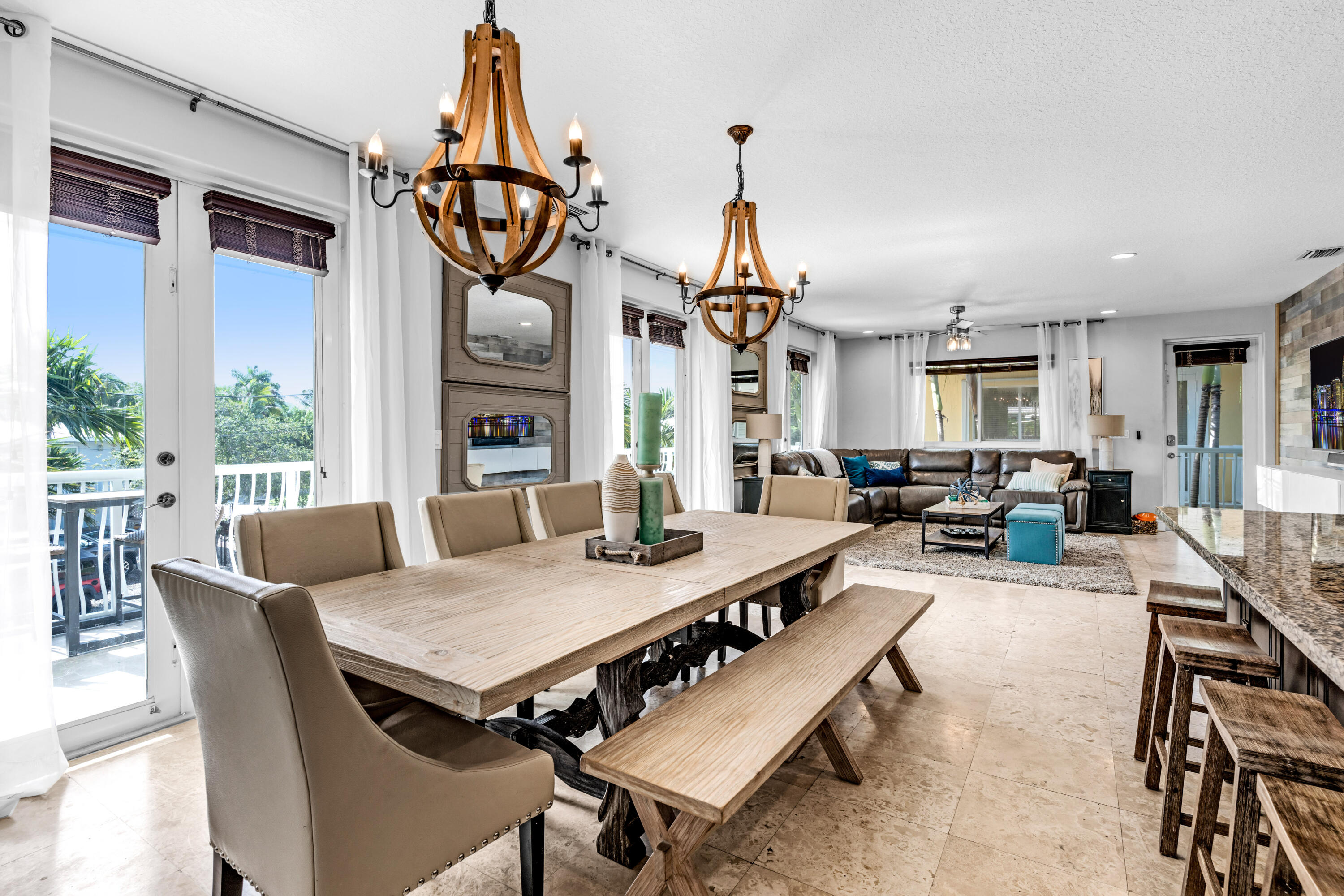 427 4th Road Key Largo, FL 33037 - Photo 10 of 51 a view of a dining room and livingroom with furniture wooden floor a chandelier