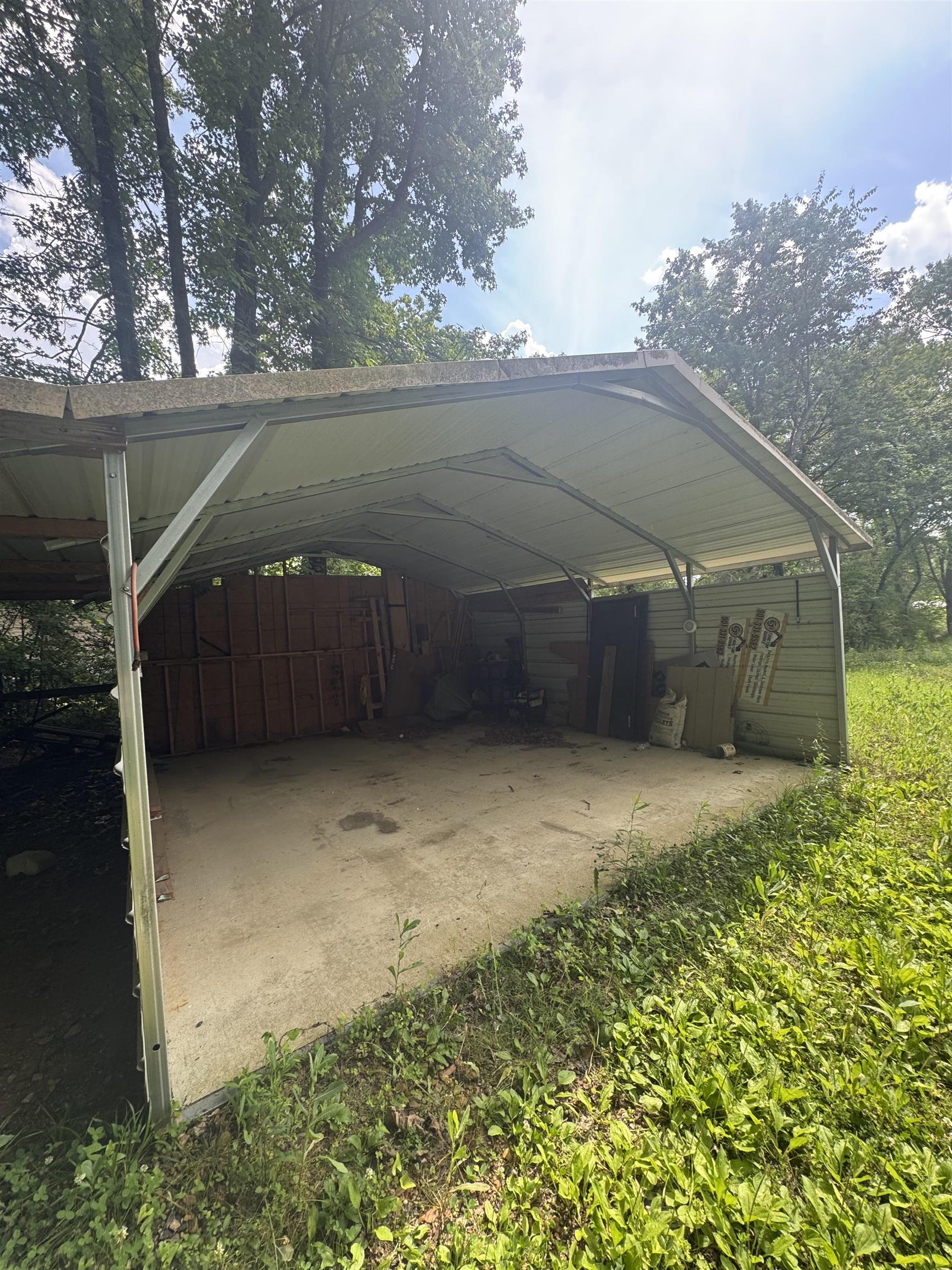 106 Cole Road Drummonds, TN 38023 - Photo 20 of 21 Metal carport structure with a concrete pad and partial perimeter siding