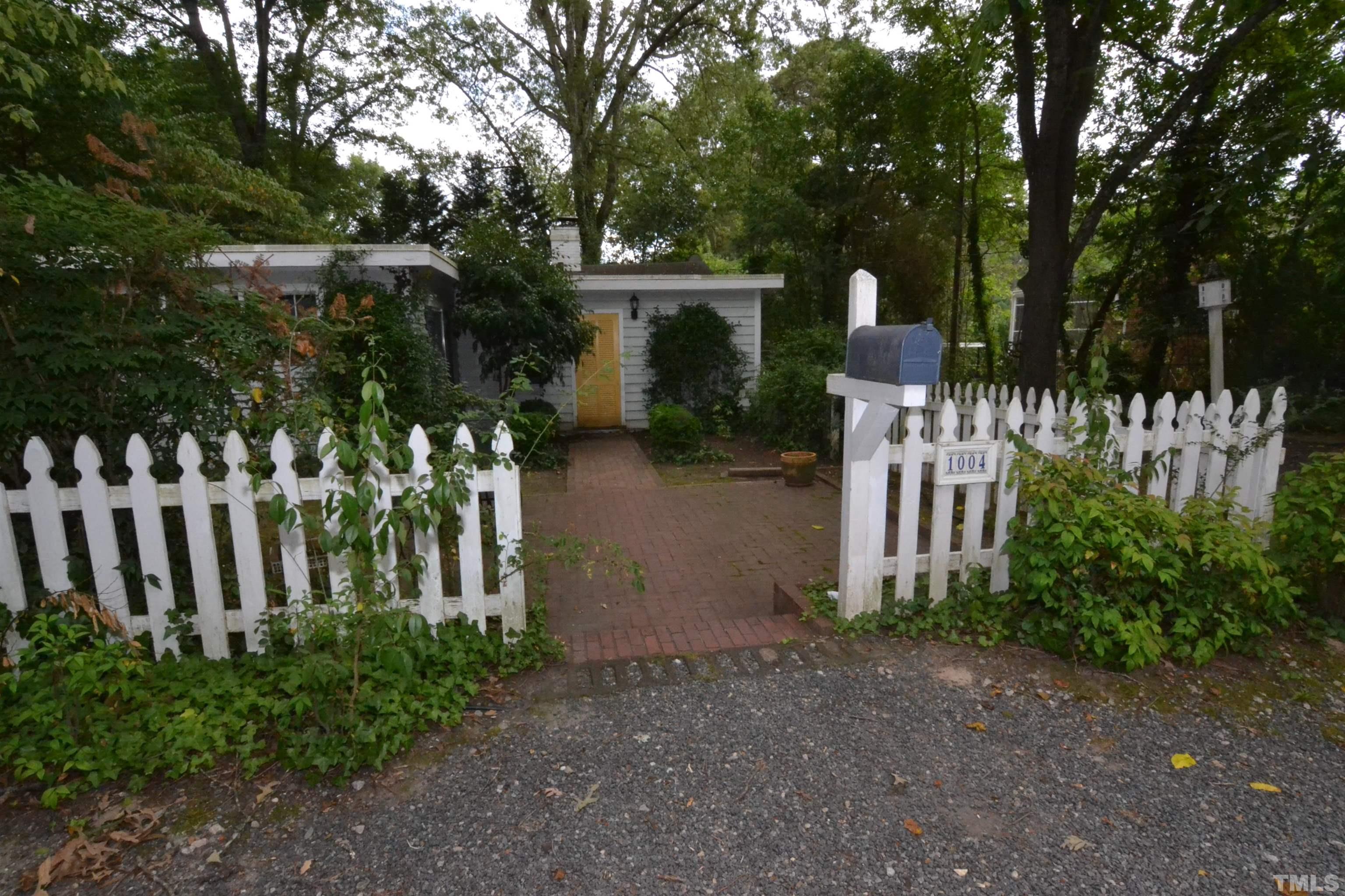 a view of a house with garden and plants