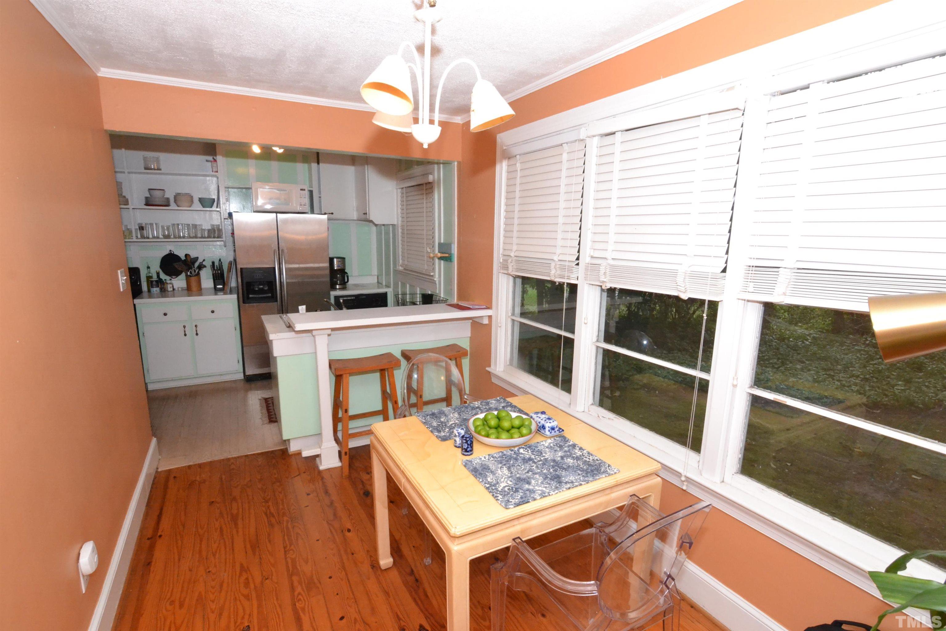 1004 Brooks Avenue Raleigh, NC 27607 - Photo 2 of 17 a living room with stainless steel appliances kitchen island granite countertop furniture and a kitchen view