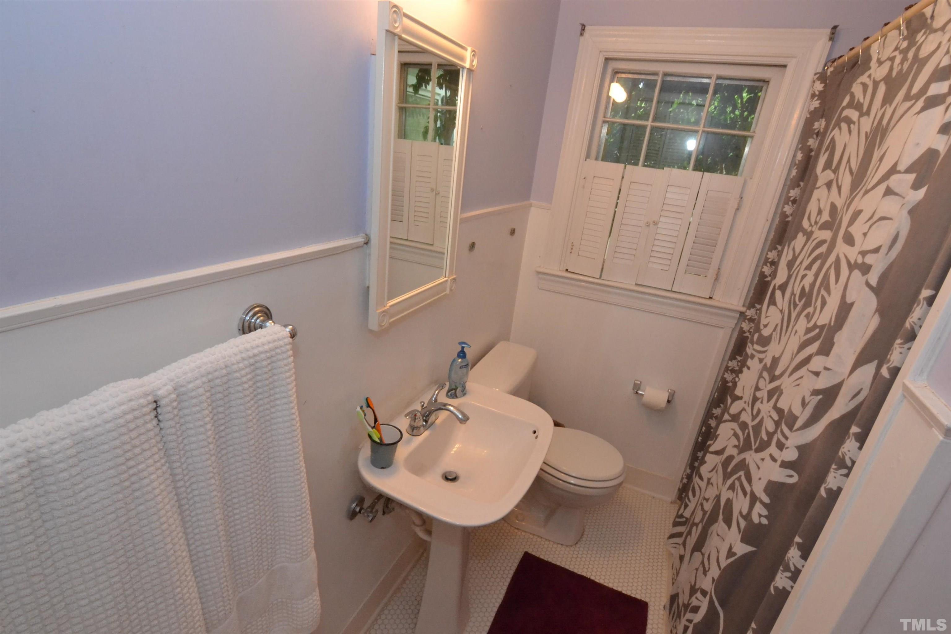 1004 Brooks Avenue Raleigh, NC 27607 - Photo 10 of 17 a bathroom with a sink toilet and shower