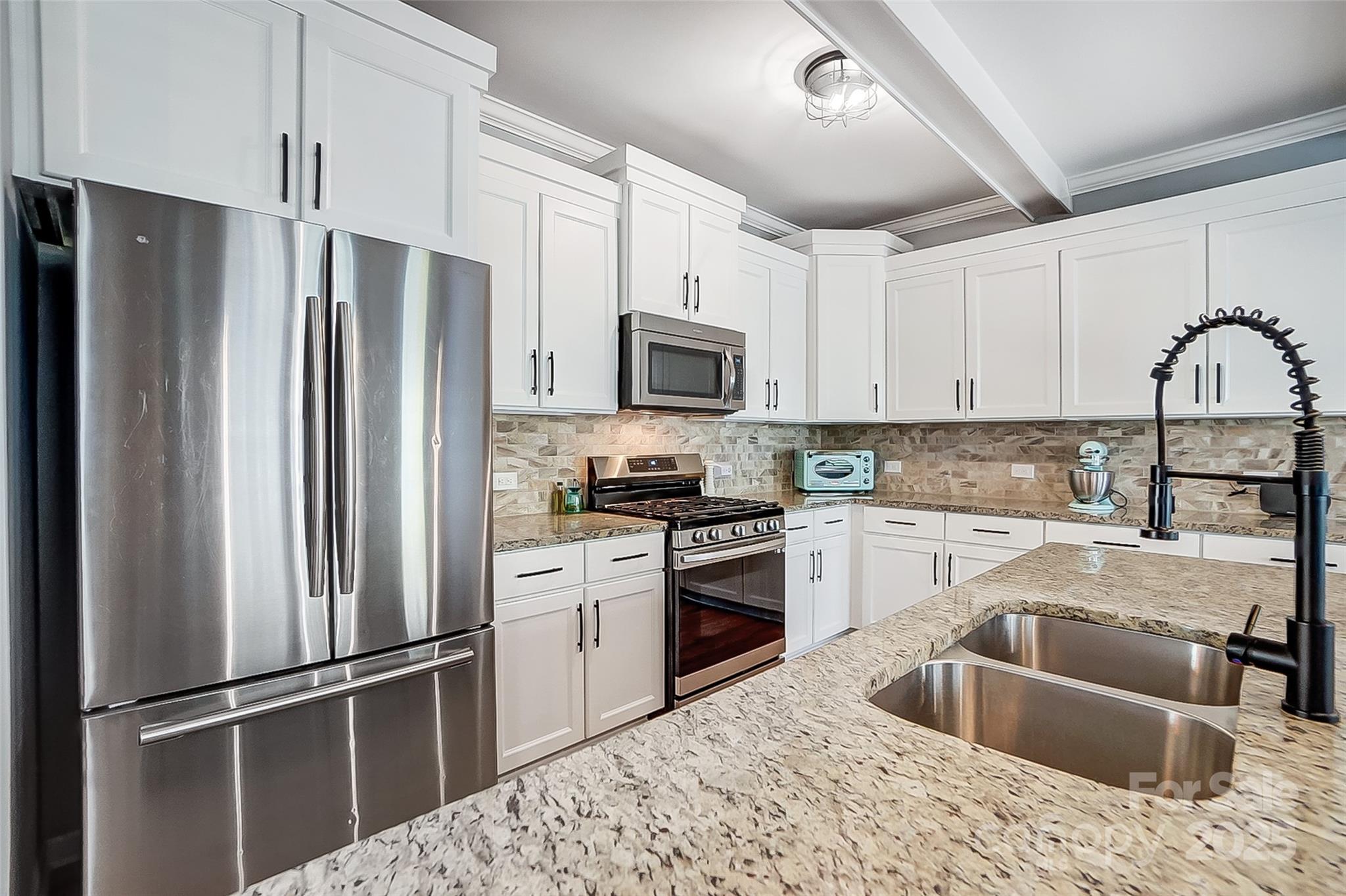 2222 Bluebell Way Fort Mill, SC 29708 - Photo 11 of 41 a kitchen with granite countertop a refrigerator stove and sink