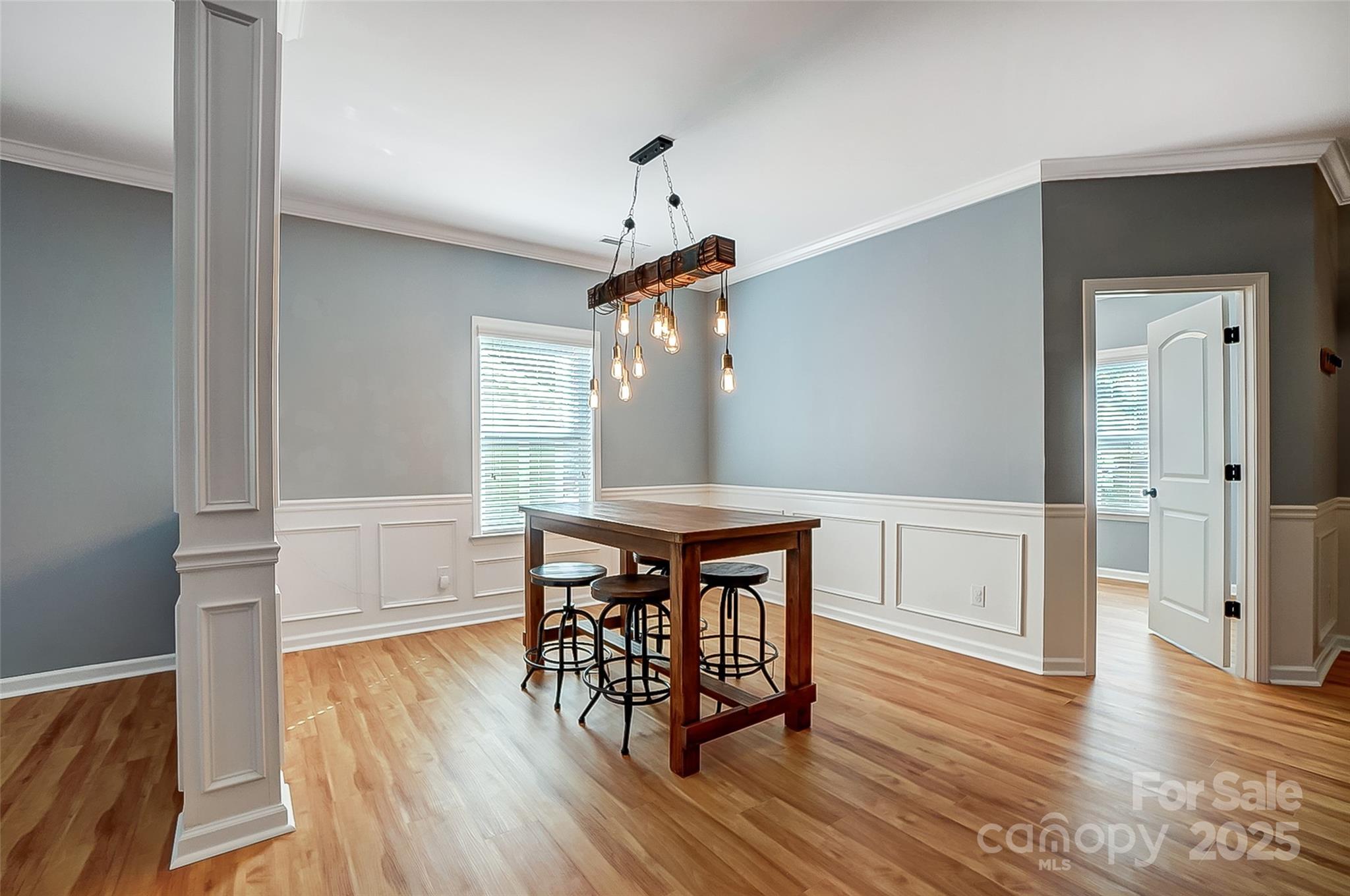 2222 Bluebell Way Fort Mill, SC 29708 - Photo 14 of 41 a dining room with wooden floor a chandelier a wooden table and chairs