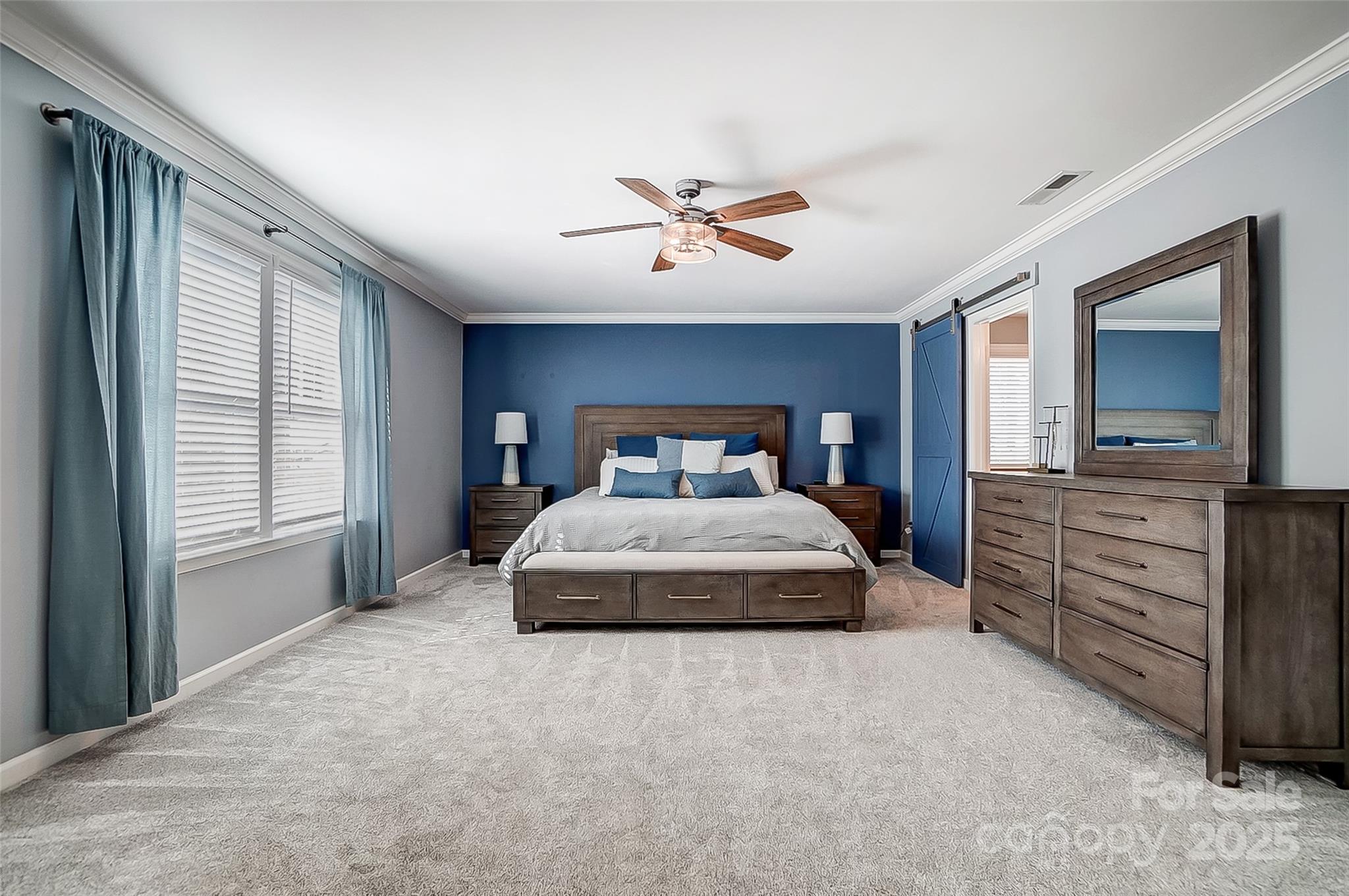 2222 Bluebell Way Fort Mill, SC 29708 - Photo 22 of 41 a bedroom with a large bed and a chandelier