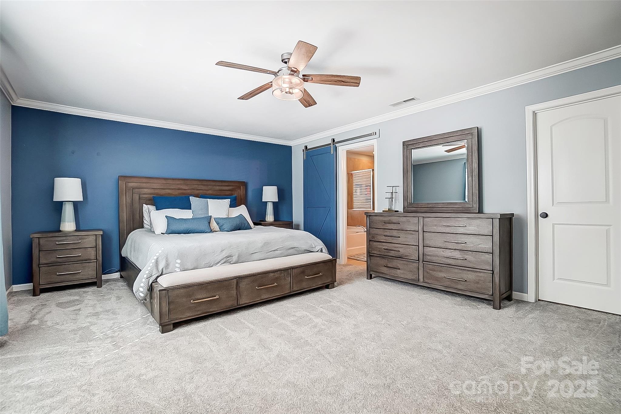 2222 Bluebell Way Fort Mill, SC 29708 - Photo 23 of 41 a bedroom with a bed and a chandelier